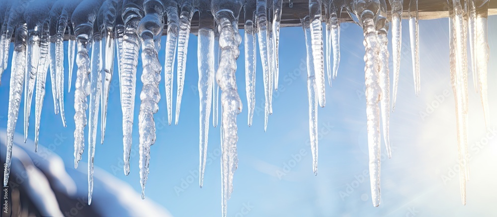 Aufkleber close up icicles hanging from the waves of the roof. copy space image. place for adding text