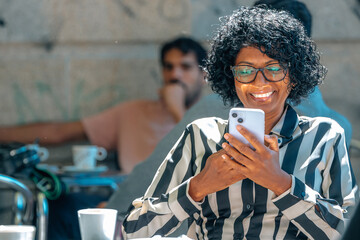 middle-aged woman with mobile phone drinking coffee