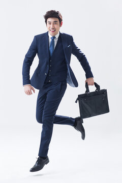 Young businessman running with briefcase