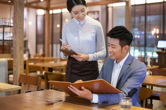 Young man ordering in restaurant
