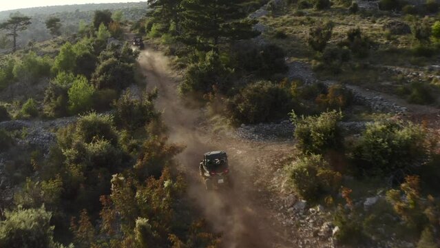 Buggy Car Driving Along Country Road, Moving Up The Hill Near Pustinja Blaca On Brac island, Dalmatia, Croatia - Drone Shot