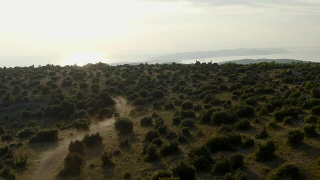 Riding A Buggy On A Dirt Road Mountains In Brac Islands, Croatia. Aerial Drone Shot