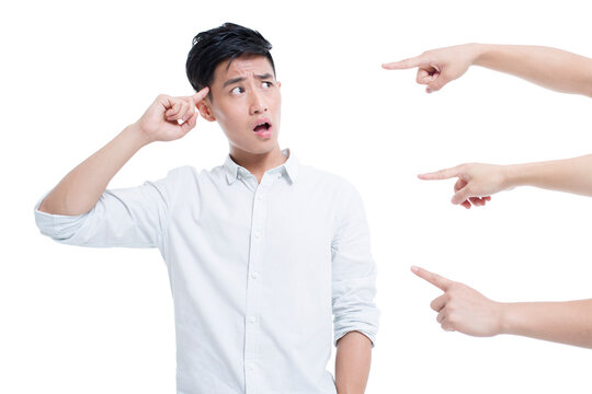 Hands pointing at a young man