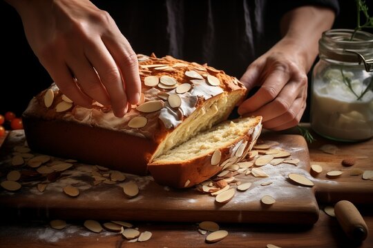 Woman Placing Traditional Tsoureki Easter Loaf with Almonds on Chopping Board