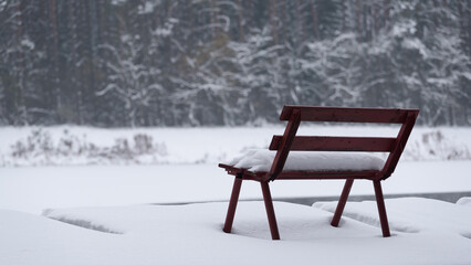 WINTER ATTACK - A bench and a fishing pier by the lake covered with snow