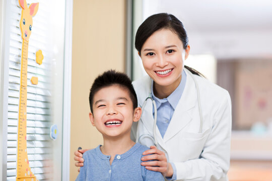 Cheerful doctor and boy in children's hospital