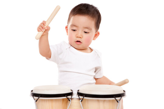 Lovely baby boy playing bongo drum