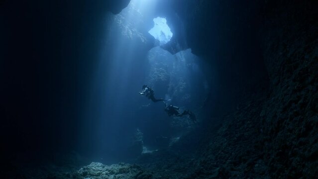 SCUBA Divers explore a large underwater cavern