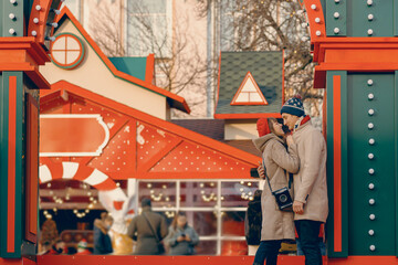 In a holiday setting, a couple shares a tender moment, connecting deeply amidst the lively charm of...