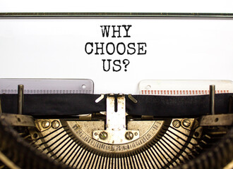 Why choose us symbol. Concept word Why choose us typed on beautiful retro old typewriter. Beautiful white paper background. Business motivational why choose us concept. Copy space.