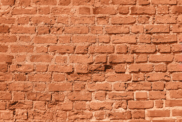 Wall of old red brick, background, peach fuzz tinting.