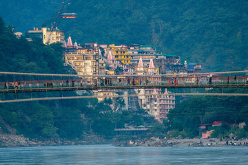 views of rishikesh city crossed by ganges river, india
