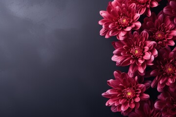 a bunch of pink flowers sitting on top of a black table next to a white vase with a red flower in it.