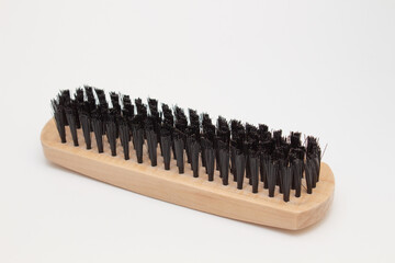 Wooden brush for clothes or shoes on a white background