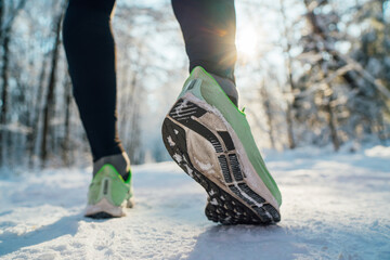 Running shoes sole close up image of winter jogger feet in running sneakers starting running on the...