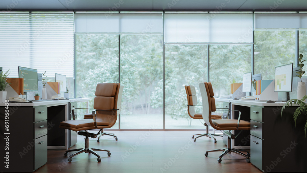 Poster a dark-toned modern minimal interior design in the office with a view of the forest outside the wind