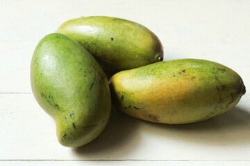 several mangoes on the table