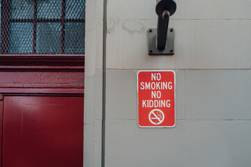 No Smoking No Kidding sign on a building in Manhattan, New York City, USA.