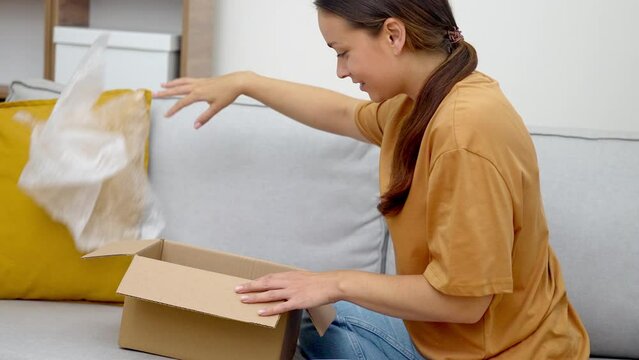 shopaholic woman embraces her fashion parcel, affirming happiness from e-commerce and rapid express online shopping.
