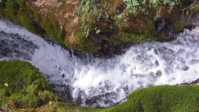 Brook water running fast in its channel.