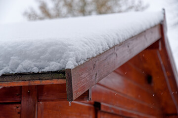 Roof of garden shed covered by snow - 691973677