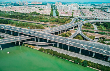 Aerial drone view of highway multi-level junction road with moving cars. China.