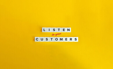Listen to Your Customers Concept. Block Letter Tiles and Cursive Text on Yellow Background. Minimalist Aesthetic.
