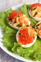 Stuffed eggs with salmon caviar are a popular appetizer for any occasion. Elegantly decorated and expertly seasoned, they will always be a beautiful appetizer at a party.