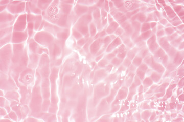 Pink water bubbles on the surface ripples. Defocus blurred transparent pink colored clear calm...
