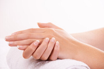 Woman, hands and french manicure in salon, spa and cosmetic care, skincare and beauty. Natural...