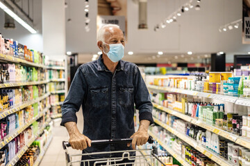 Supermarket, shopping and customer with covid face mask in retail store for food, groceries or...