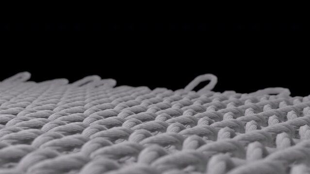 Close up of knitting fabric, material threads weaving animation.