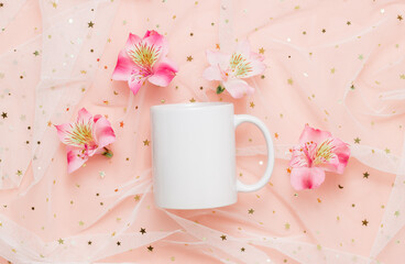 White mockup mug with pink flowers on fabric with glitter, top view. Mockup mug for logo, label, gift and design.
