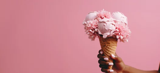 Foto auf Alu-Dibond a hand holds a pink ice cream cone in front of a pink flower © ArtCookStudio