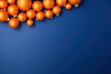  a group of orange balls floating in the air on a blue background with a space for the word w in the middle of the image. - Powered by Adobe