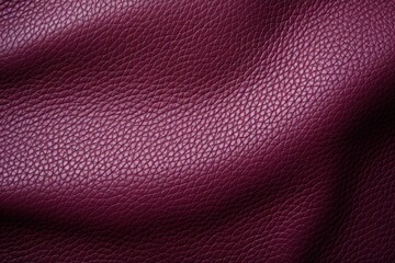  a close up view of a purple leather textured up to the surface of a leather sofa or chair cushion.