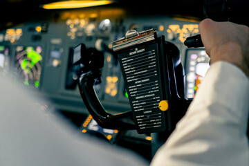 close-up Pilot in the cockpit of an airplane holding a rotary steering wheel during a flight Air...