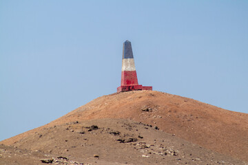 tricolor monolith in the desert, marking a historic site of the Pacific War
