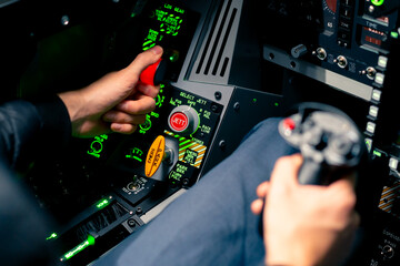close-up of the cockpit of a military plane a pilot with a steering wheel and many buttons on the...