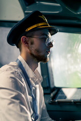 The pilot in the cockpit controls the plane during flight turbulence flight simulator and...