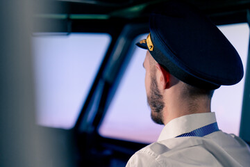 portrait of a pilot in the cockpit controlling the plane during flight turbulence flight simulator and transportation