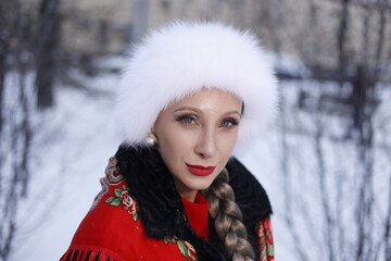 Woman with big braid in brown retro fur coat in winter street with snow. Winter cold weather. Girl...