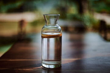 bottle of water and coffee on the table with nice bokeh and colors - 692016037