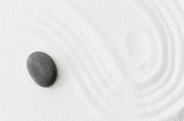 Fototapeta na wymiar Zen Stone in Japanese garden with grey rock sea stone on white sand texture background, Yin and Yang symbol of dualism in ancient Chinese philosophy.Harmony,Meditation,Zen like concept