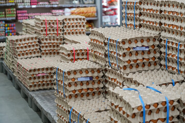 Many stacks of rows and paper packaging for chicken eggs, stacked in a store, brought from poultry...
