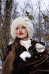 Woman with big braid in brown retro fur coat in winter street with snow. Winter cold weather. Girl...