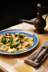 Vegetarian pasta with broccoli potato and tomatoes