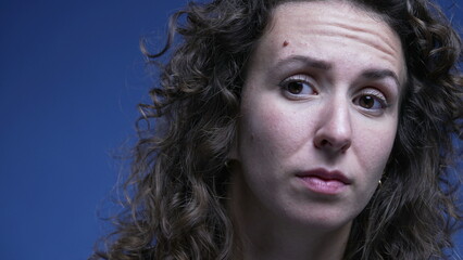 Woman in doubt listening close-up face with question mark expression lifting eye brow feeling confused