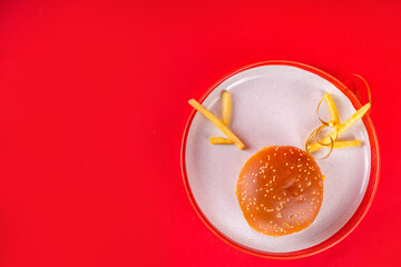 Christmas burger and french fries delivery menu. Big cheeseburger with french fries and ketchup sauce on festive Christmas and New Year decorated background