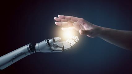 Robot hand touch human hand, the concept of using artificial intelligence technology or Machine...
